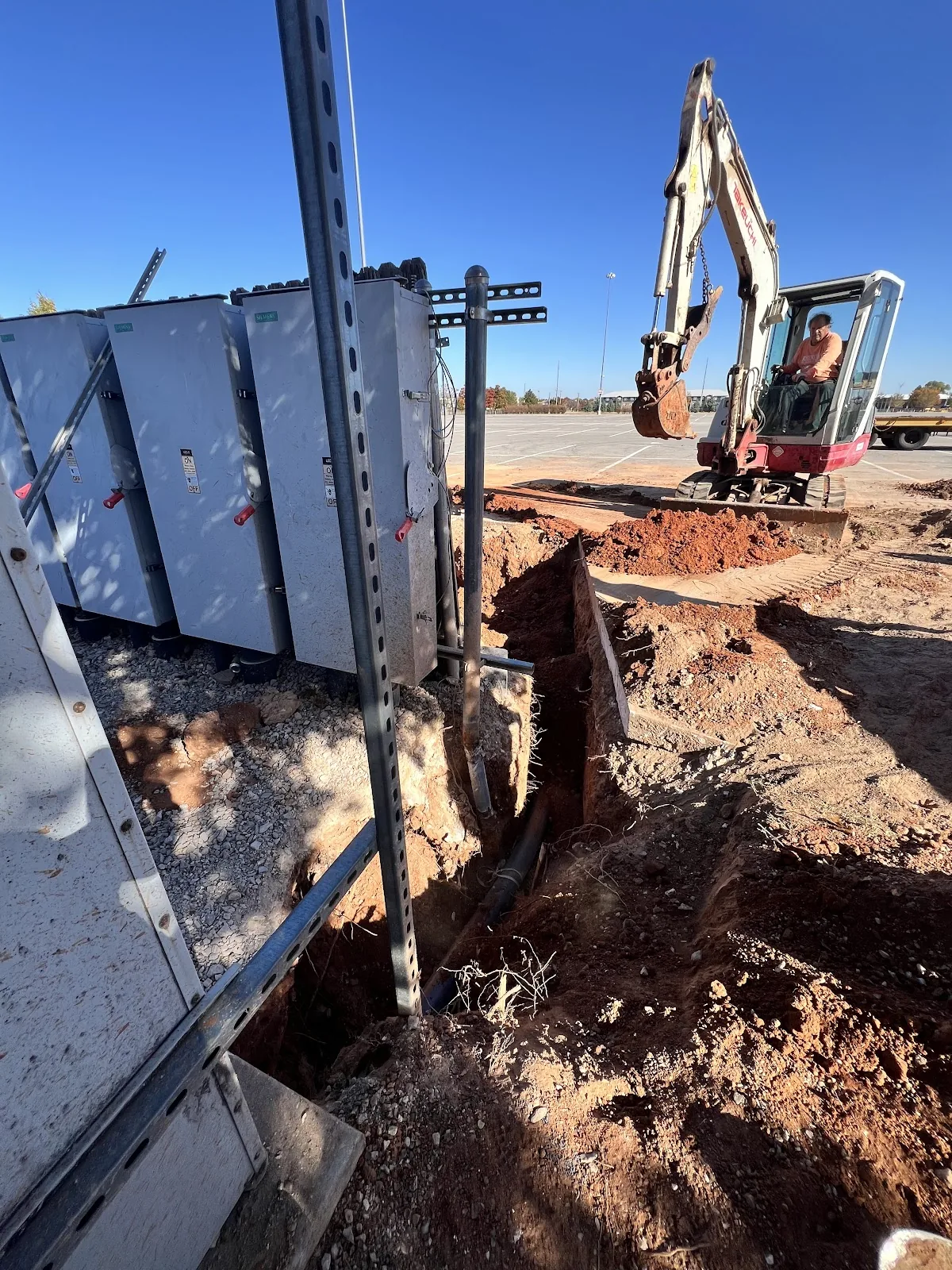 Large horizontal directional drilling rig with mud support truck staged for a long bore