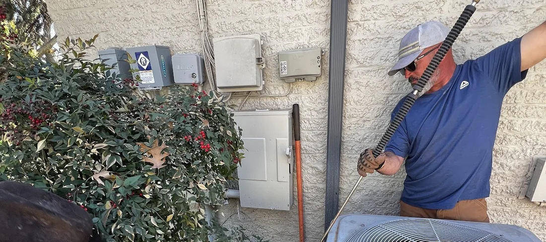 Crew member boring under a structure for a plumber's water or sewer service line