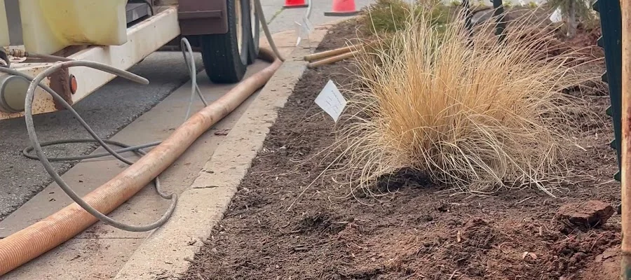 Crew laying underground conduit in a street trench for an electrical contractor