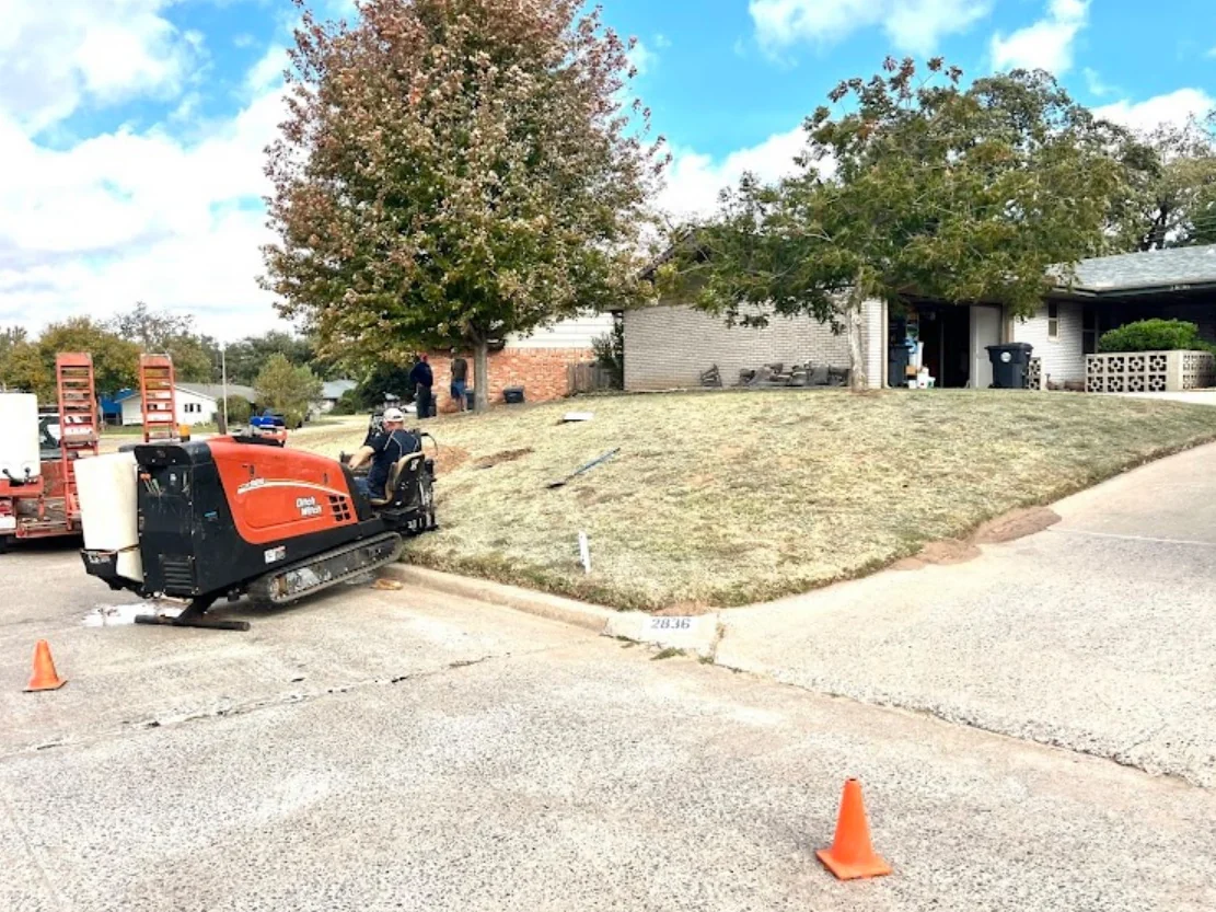 Excavator clearing a bore pit on an active directional drilling site