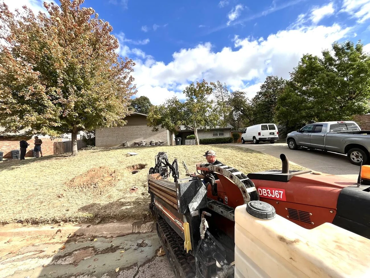 Bore pit with drill string entering the ground on a utility job